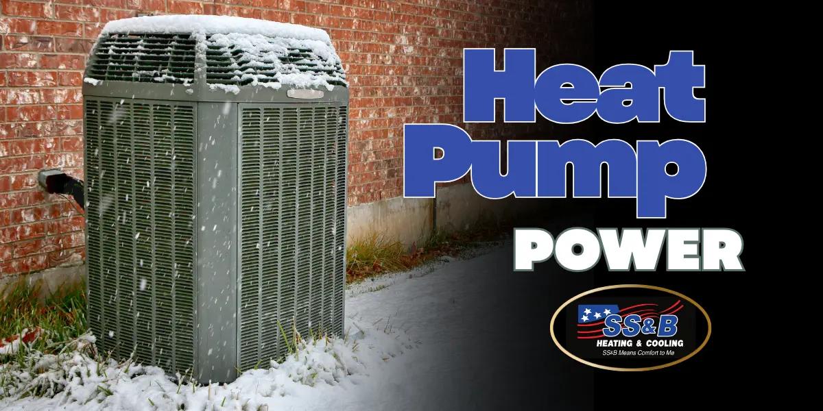 Heat pump unit covered in snow outside a Springfield, MO home, showing winter performance and reliability. SS&B Heating & Cooling branding displayed.