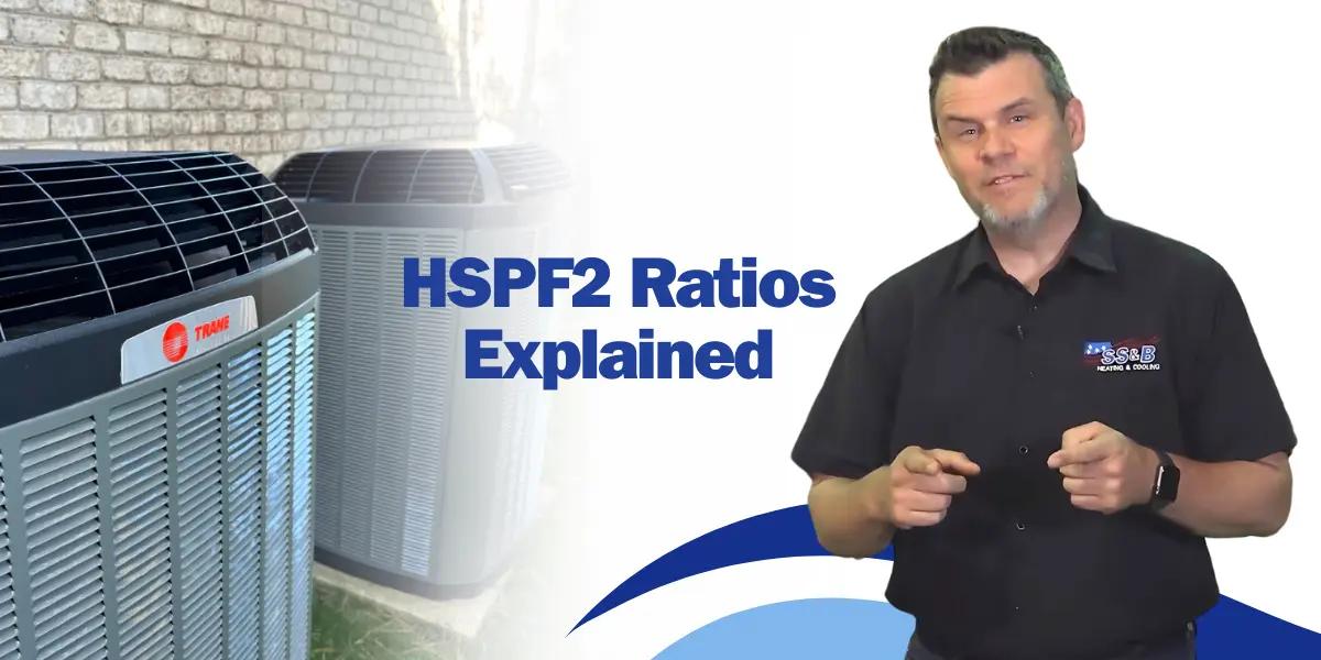 Two Trane XL heat pumps positioned side by side outside a house. The house's exterior wall and surrounding grass are visible, illustrating efficient Trane HVAC systems.