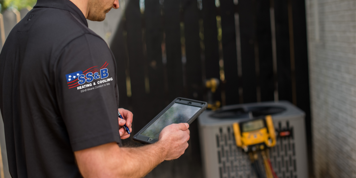SS&B Heating & Cooling servicing an AC in Springfield, MO