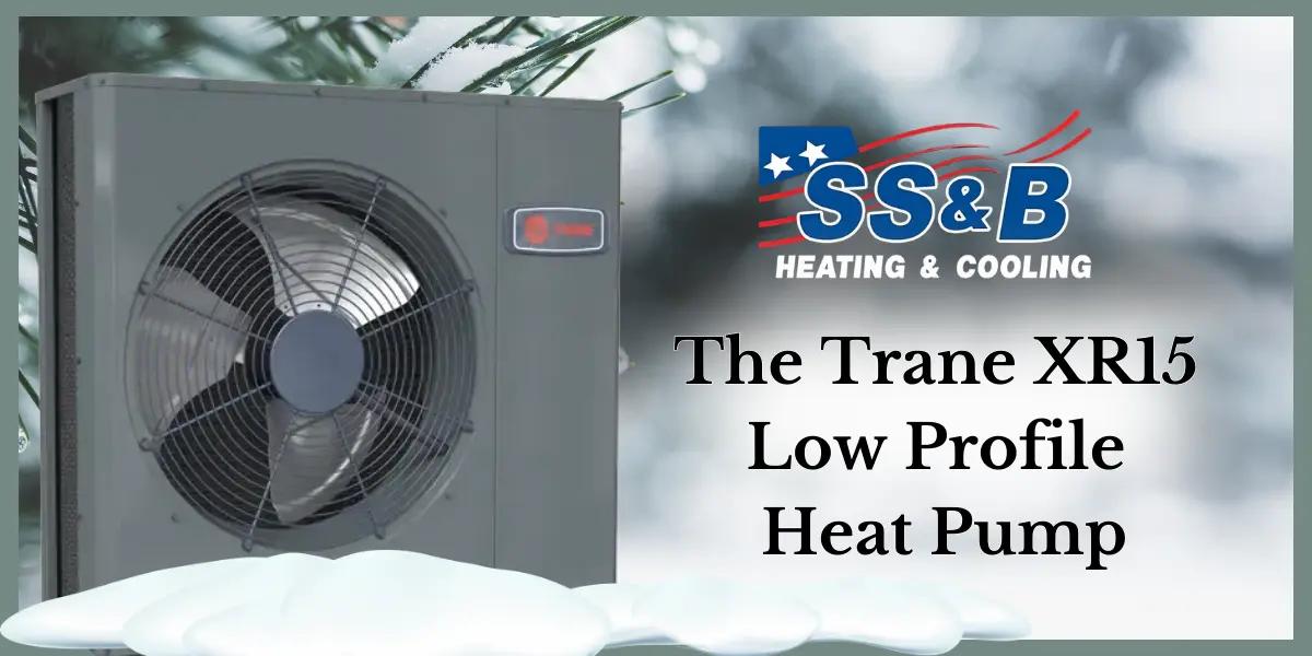 An image of the Trane XR15 Low Profile Heat Pump unit set against a snowy background with pine branches. The text on the right side reads 'The Trane XR15 Low Profile Heat Pump' in bold letters. This image highlights the heat pump's ability to perform efficiently in all weather conditions.