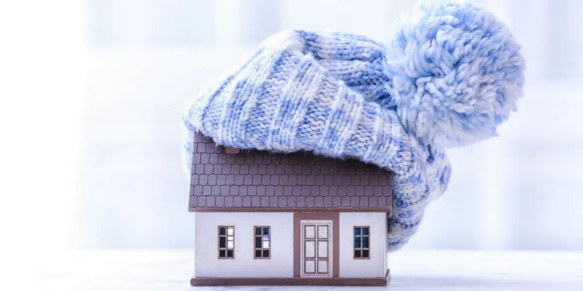 Springfield home in winter, humorously adorned with a large yarn cap, symbolizing warmth and energy efficiency.