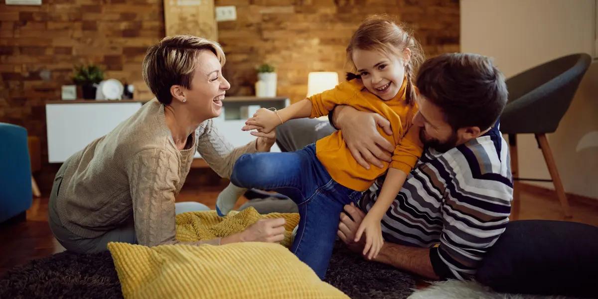 Happy family enjoying indoor comfort, symbolizing the benefits of optimal climate control.