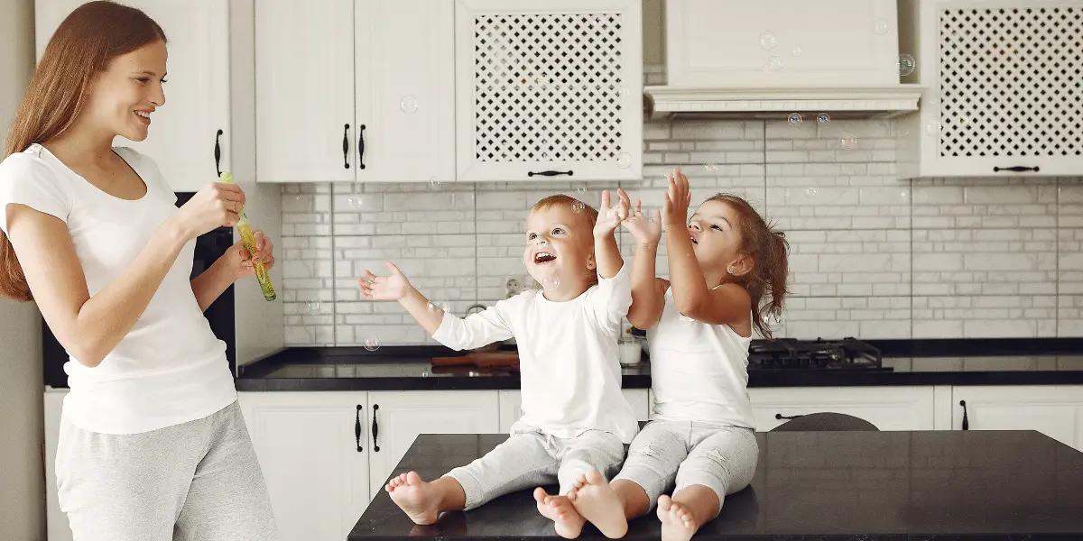 Mother and children enjoying comfort in their kitchen, symbolizing the optimal climate provided by Daikin AC equipment.
