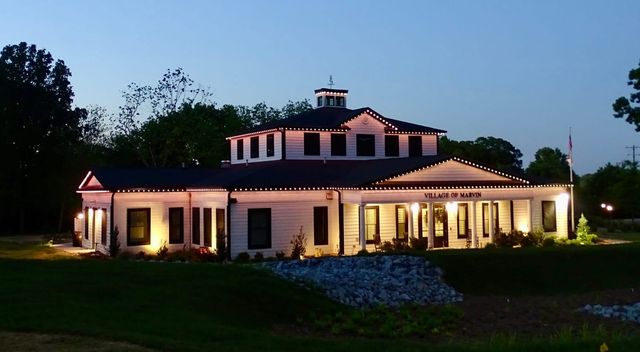 A civic hall outlined in warm white at dusk