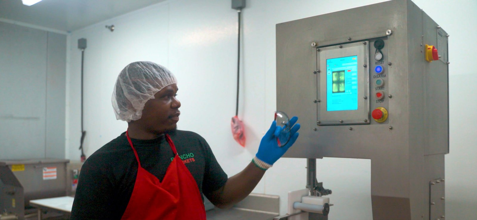 Rancho Markets meat cutter presenting a gloved hand to the Guardian vision system