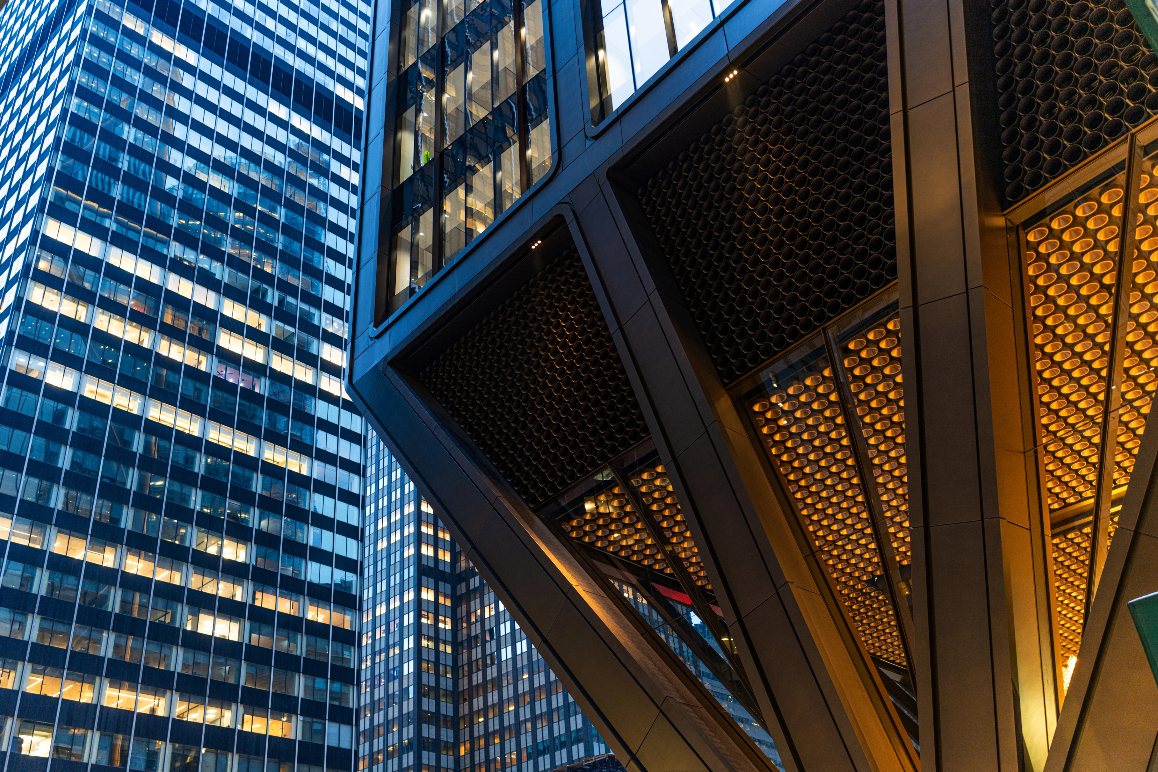 Glass office towers in a financial district, lit at dusk