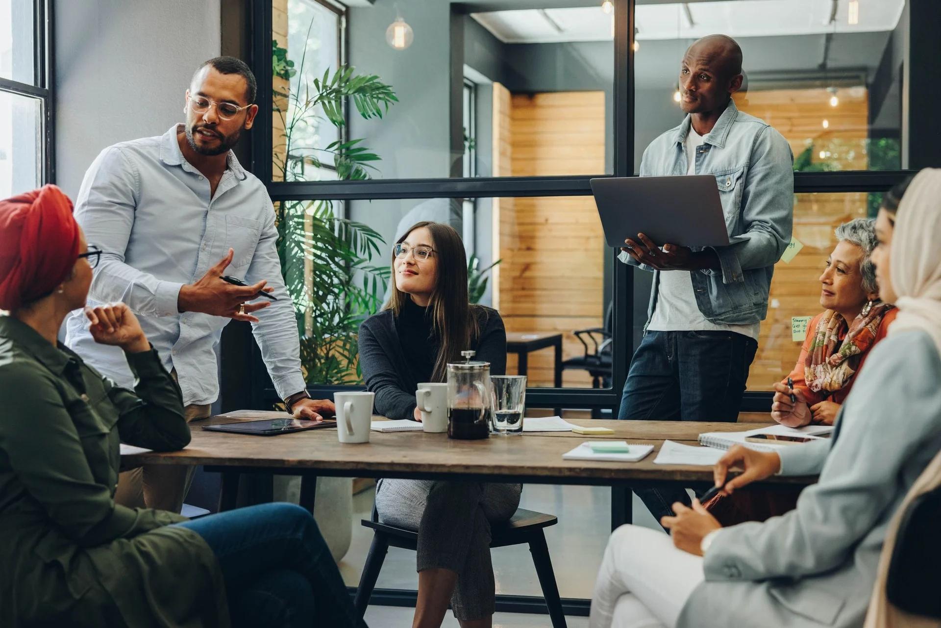 A team meeting around a table in a bright office