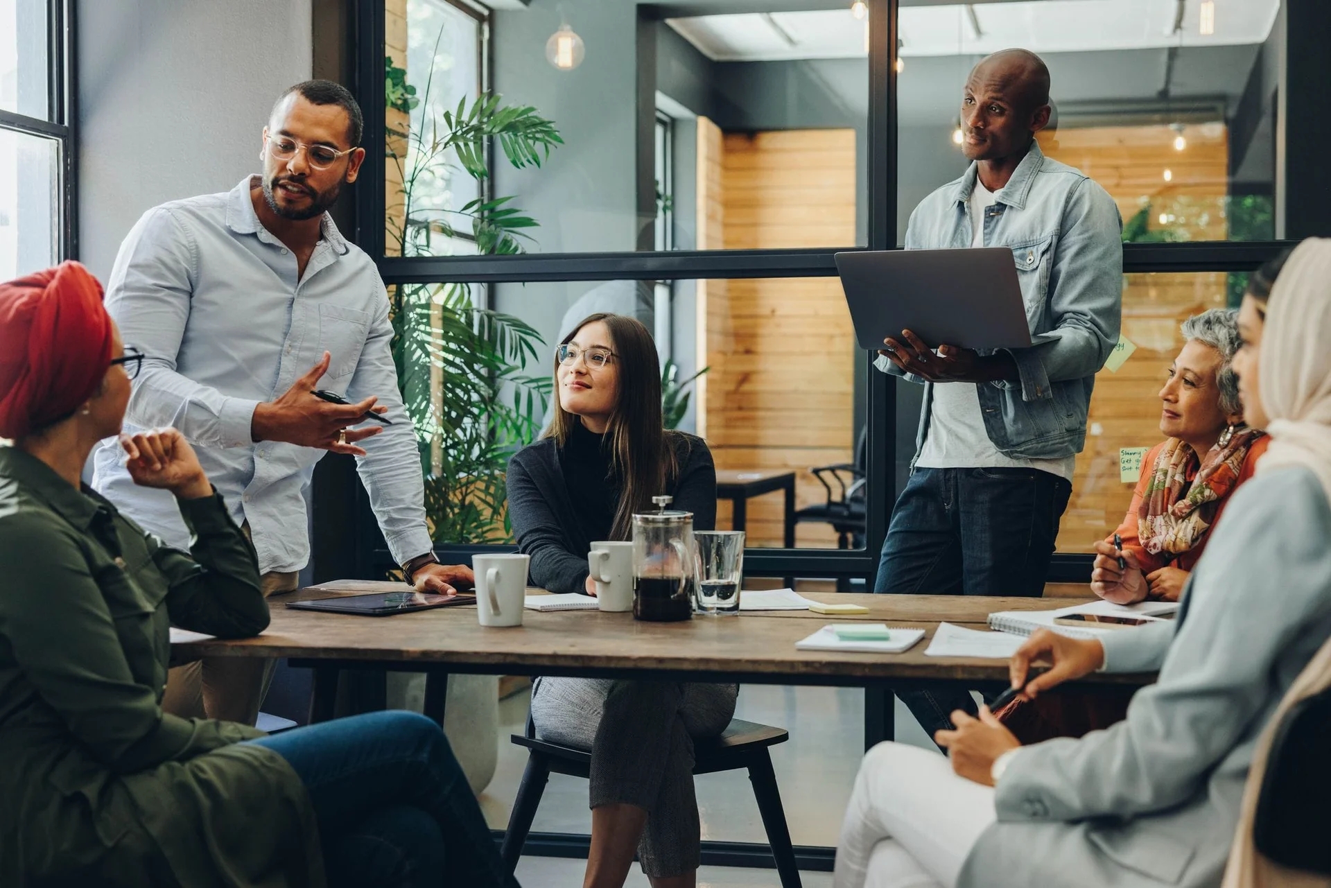 A team meeting around a table in a bright office