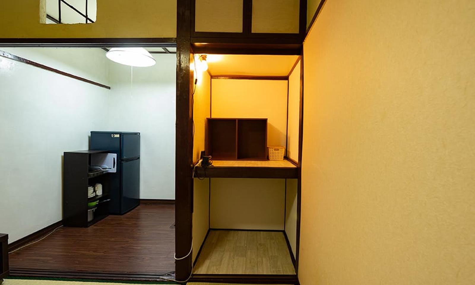 The closet can double as a desk with a lamp, bookshelf, and multiple wall outlets.