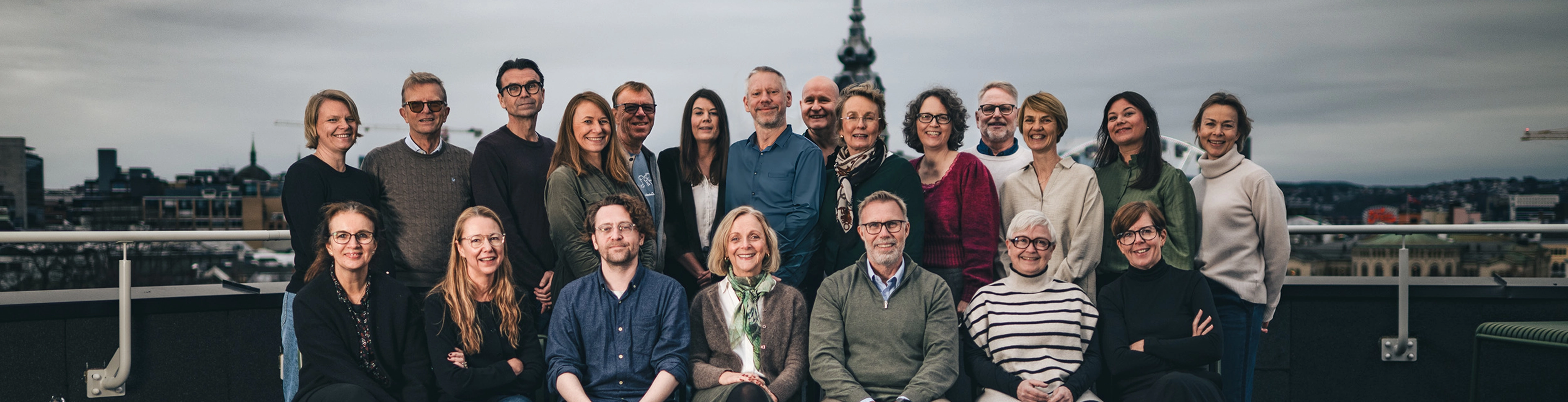 BIlde av de ansatte i Cappelen Damm Akademisk på taket av Stortingsgata 28 en grå høstdag