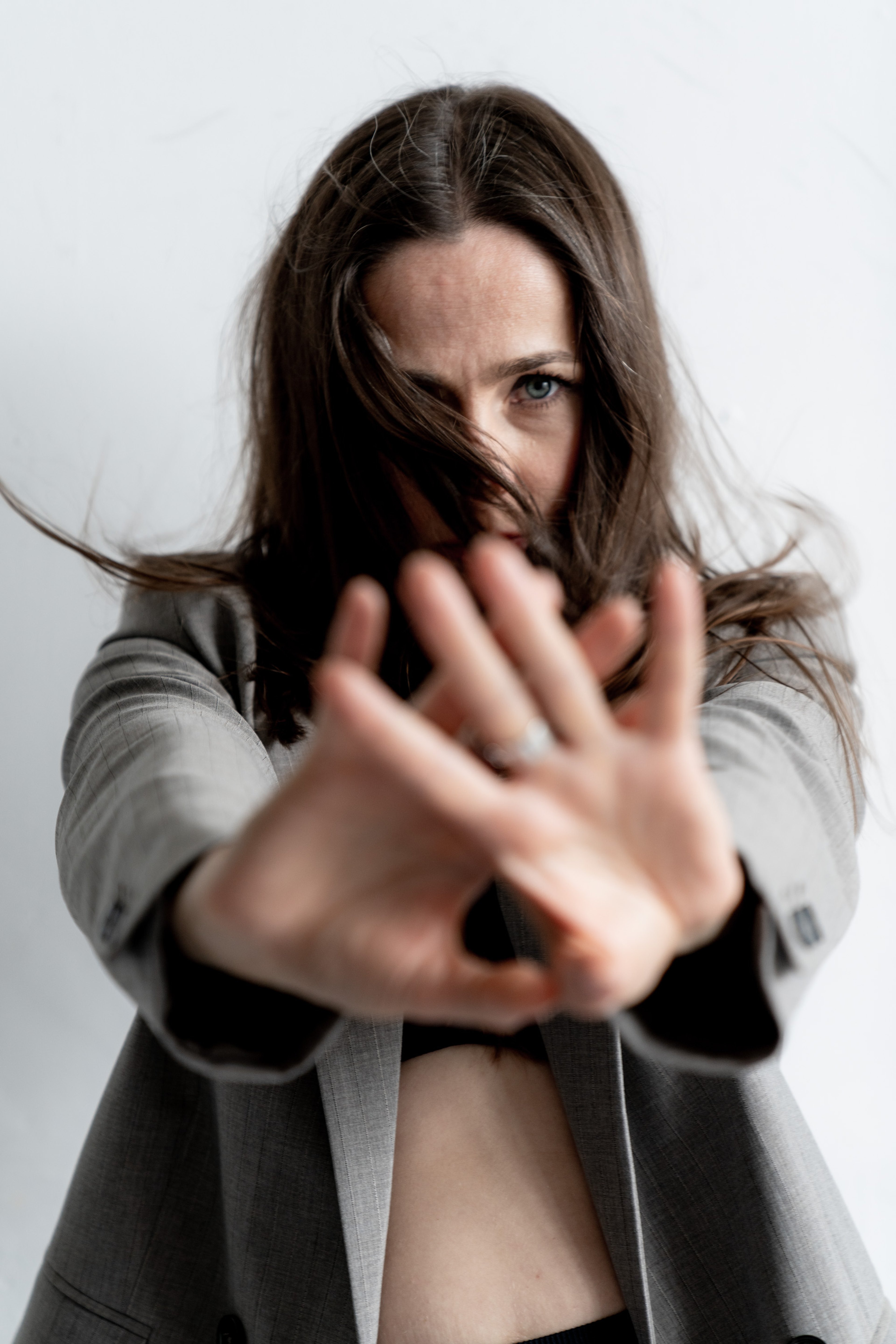 Inga reaching towards the camera, hair across her face