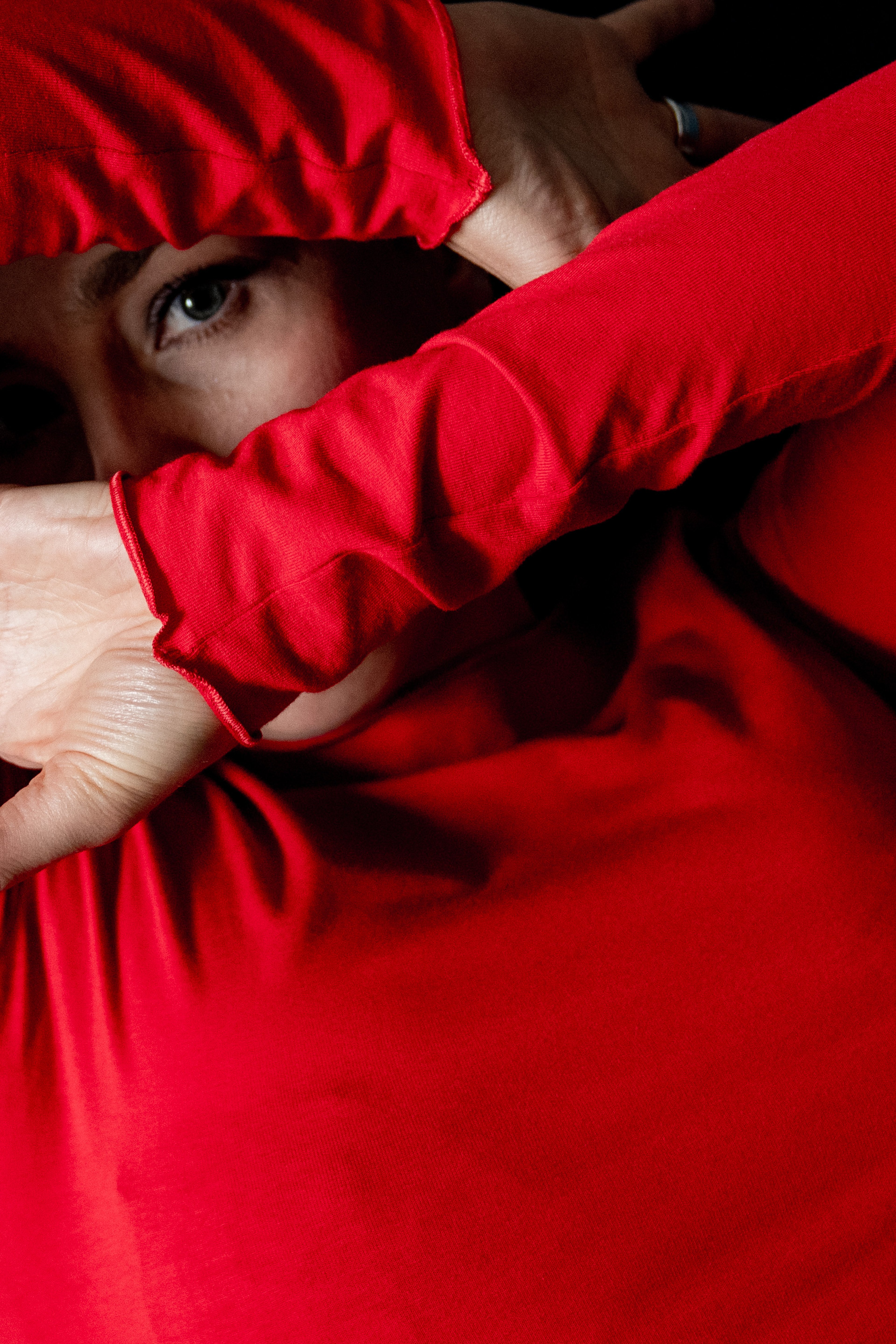 Inga half hidden behind a red sleeve
