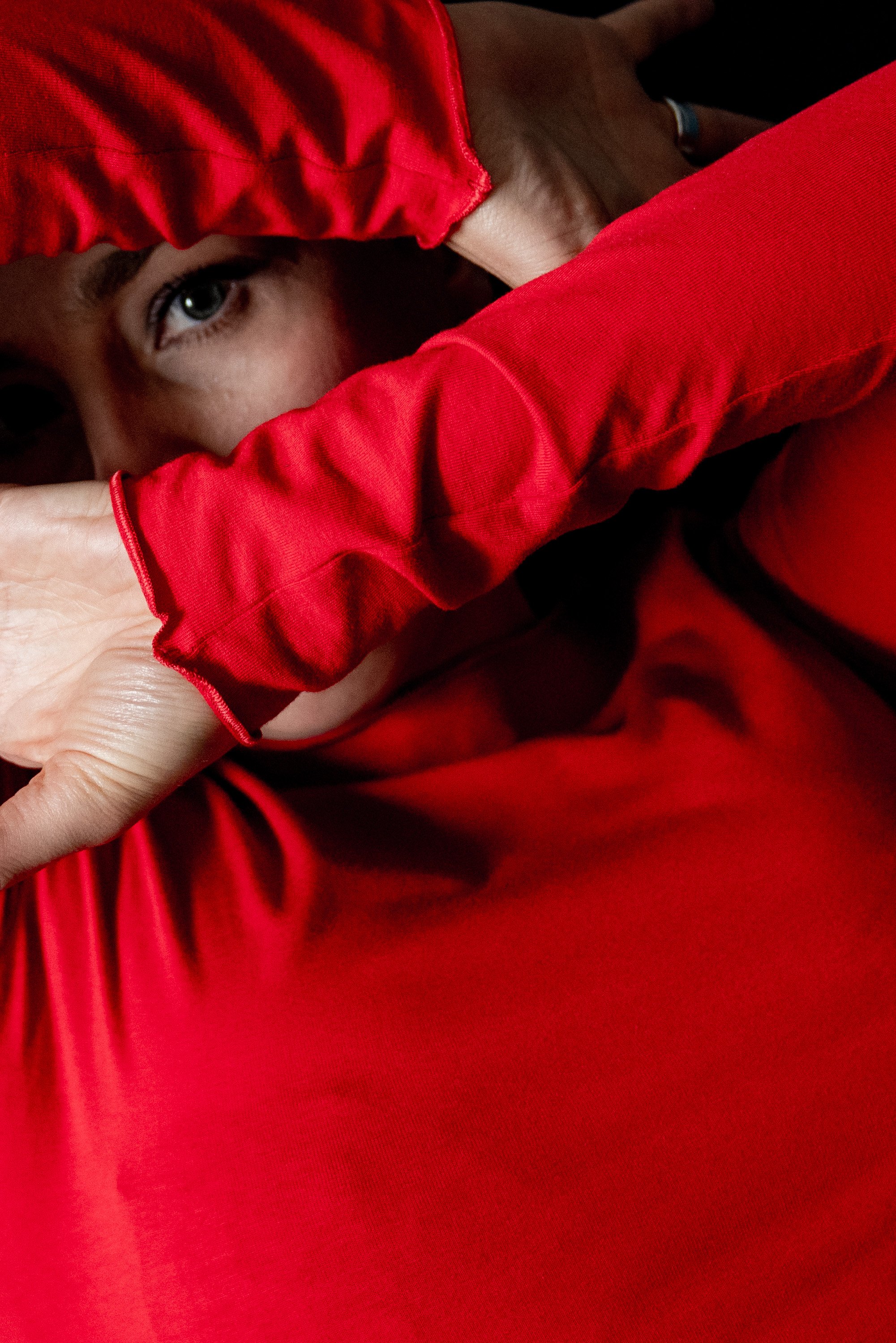 Inga half hidden behind a red sleeve