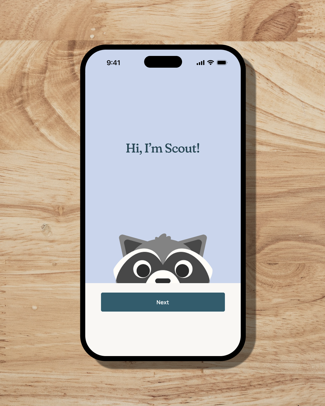 A phone on a wooden counter top that says, "Hi, I'm Scout!"