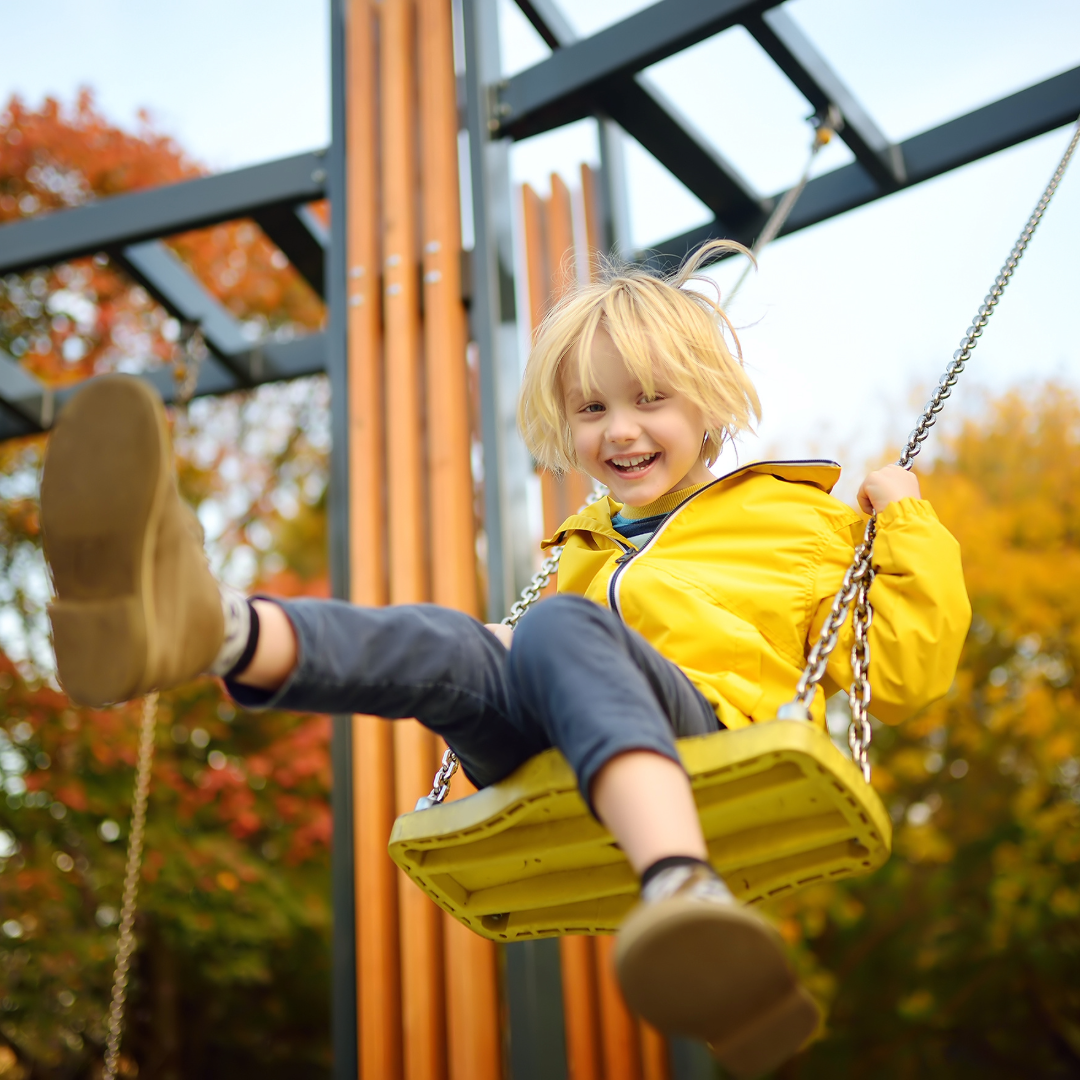 Kind lachend op schommel