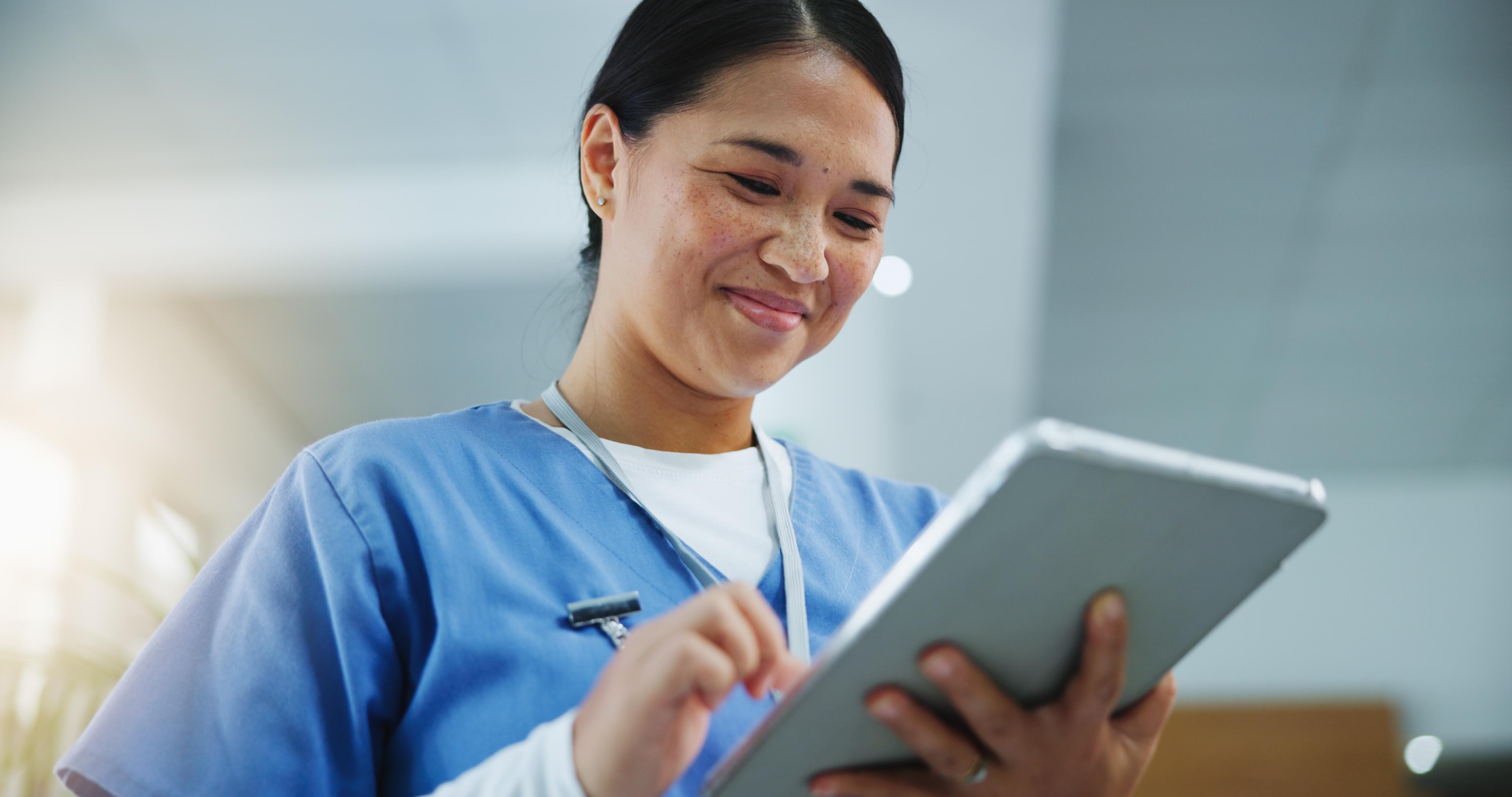 Women smiling looking at tablet