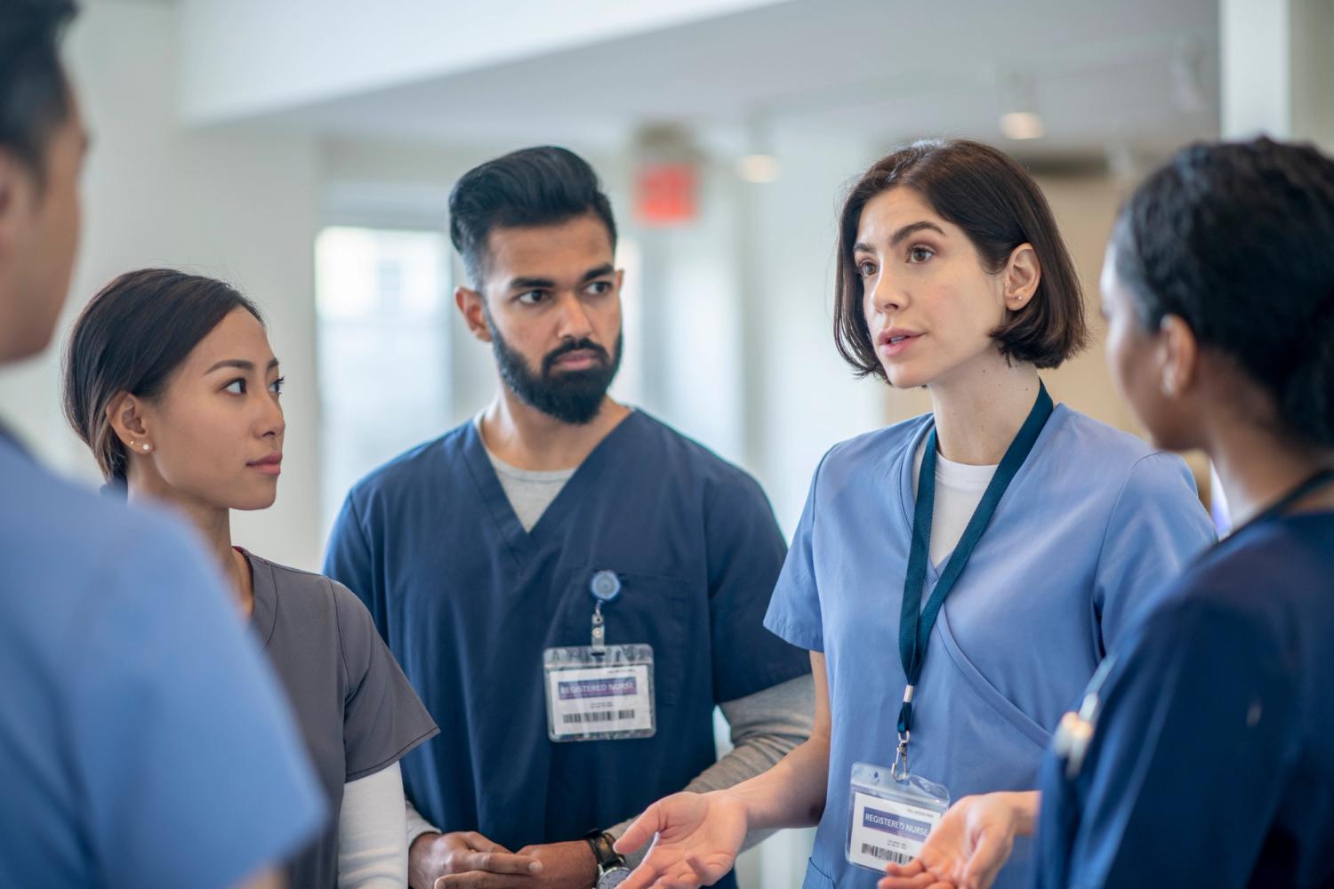 Healthcare team members discussing patient care in a hospital setting.