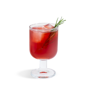 red fizzy drink with a rosemary sprig in a glass with a short stem