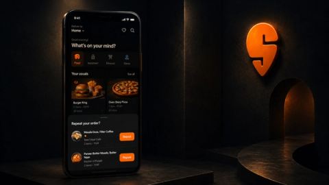Dark-themed food delivery app interface displayed on a smartphone, featuring personalized meal recommendations, repeat order options, and restaurant listings with glowing orange UI accents in a cinematic low-light setting.