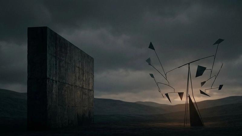 Concrete monolith and abstract geometric structure in a dark landscape at dusk.
