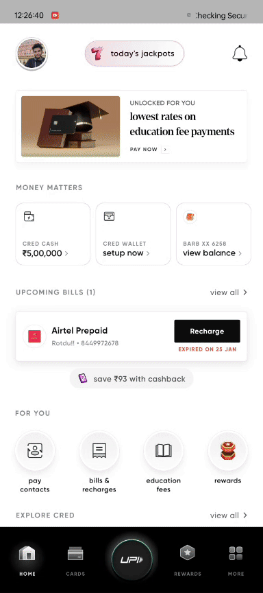 “Mobile finance app home screen showing account overview, promotional banner for education fee payments, wallet and cash options, upcoming bill reminder, quick actions like bill payments and rewards, and a bottom navigation bar with UPI and cards.”