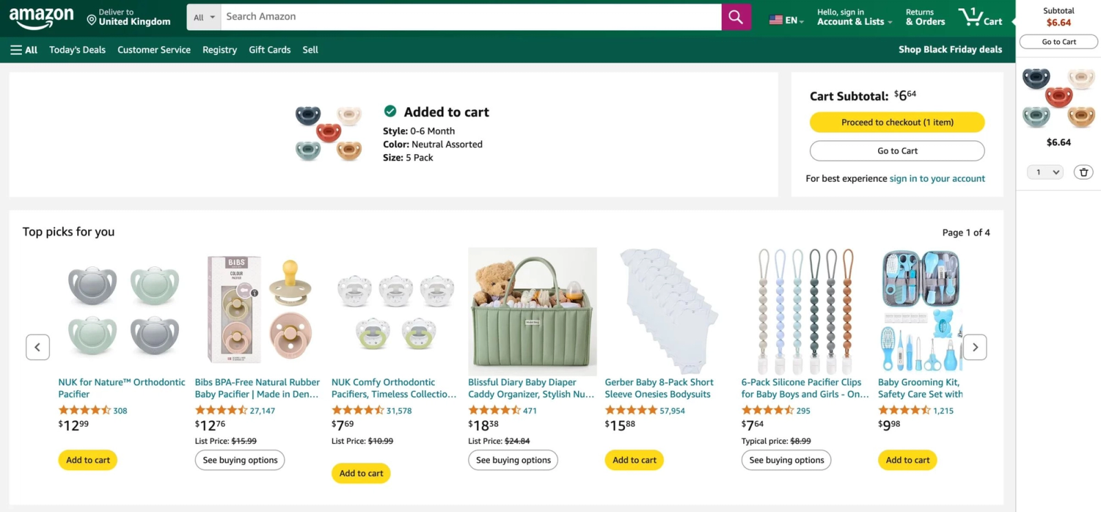 Amazon shopping cart page showing a pacifier recently added to the cart, with a "Top picks for you" recommendation carousel displaying related baby products such as pacifiers, onesies, pacifier clips, diaper organizers, and grooming kits, alongside checkout and cart summary options.