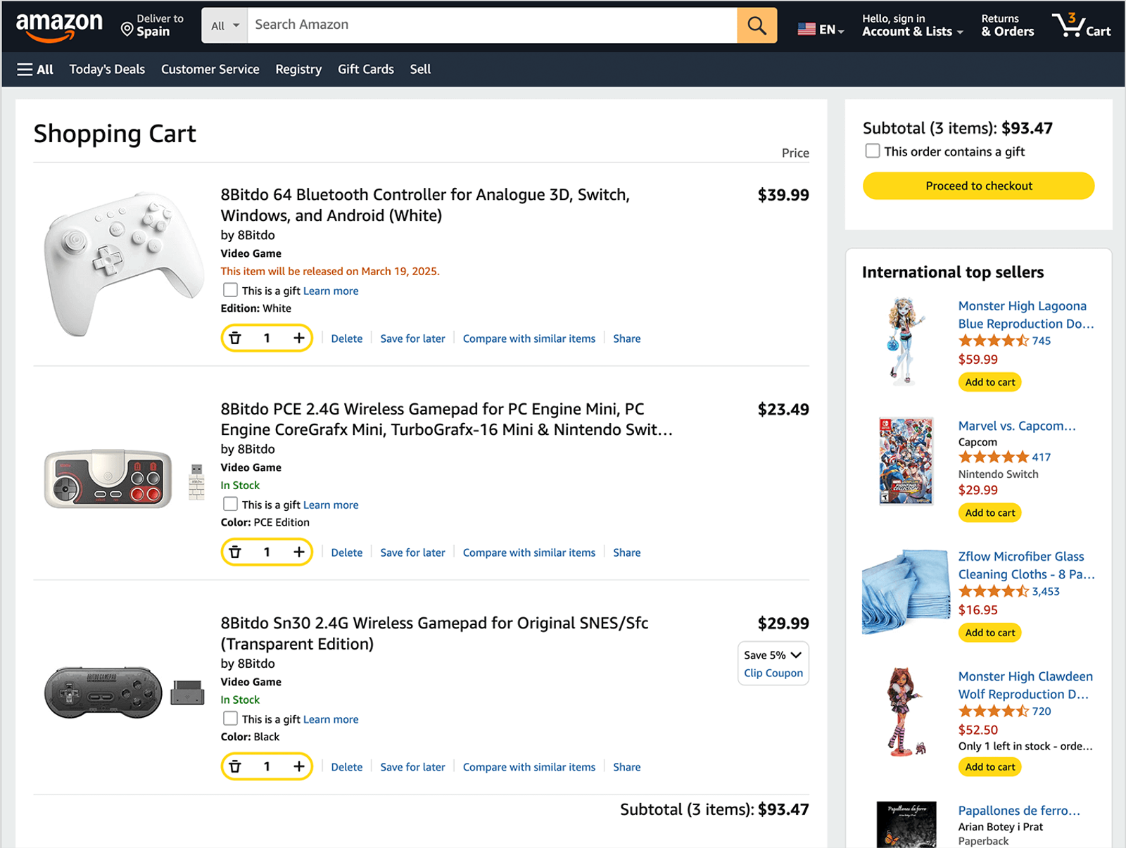 Amazon shopping cart page showing multiple retro gaming controllers in the cart, with a checkout summary panel on the right and an inline recommendation section featuring additional products such as games, collectibles, cleaning accessories, and toys. The recommendations appear alongside the cart contents, encouraging add-on purchases without interrupting the checkout flow.