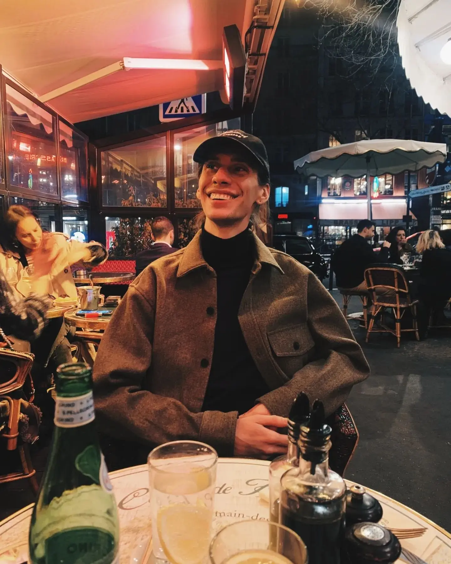 Austin enjoying an evening dinner on a patio in Paris