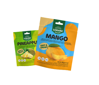 Two pouches of Sunshine Delights soft & chewy dried fruit, one pineapple and one mango.