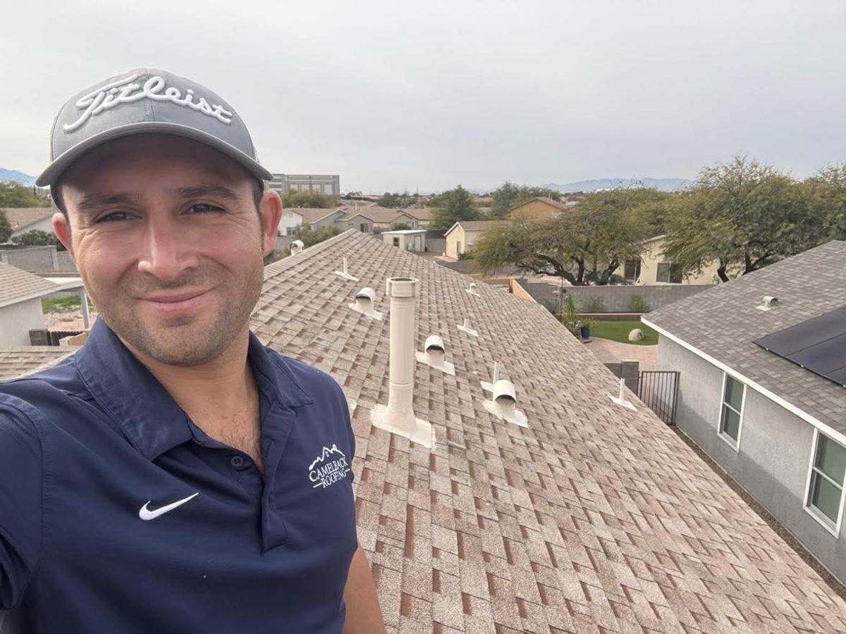 David Barajas walking a Tucson roof during a free inspection