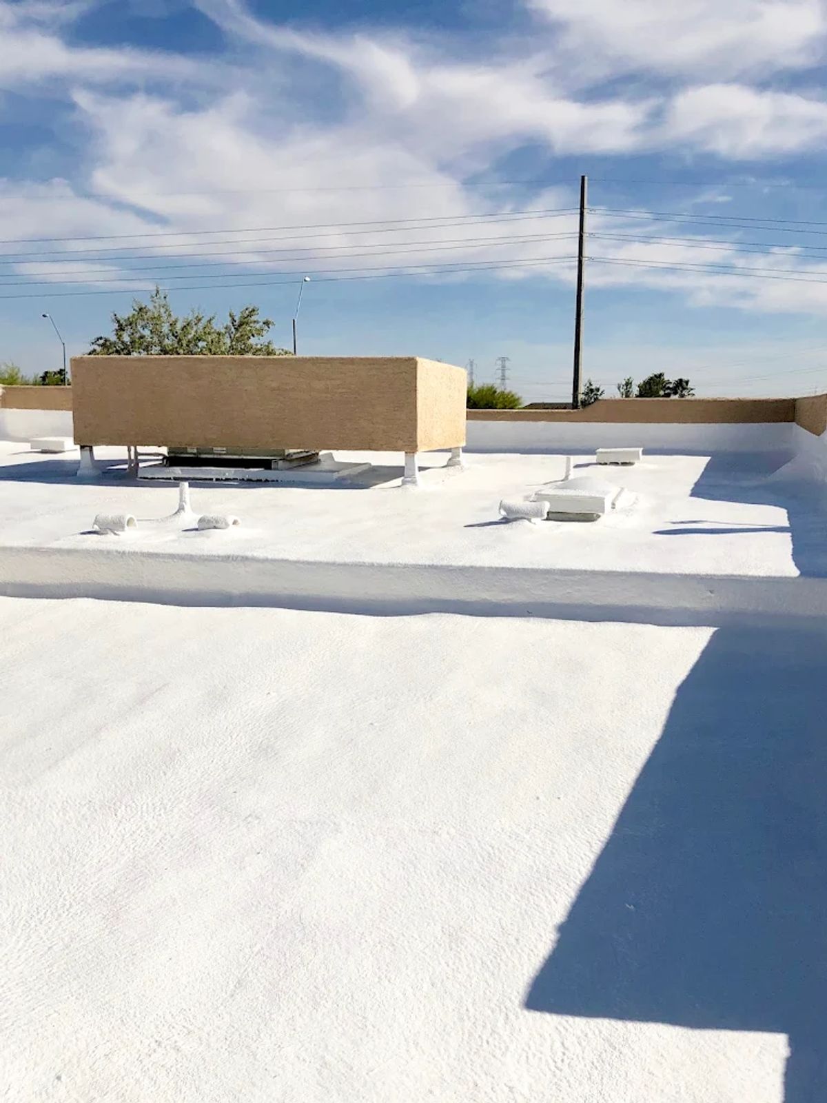 Commercial flat roof with white elastomeric coating