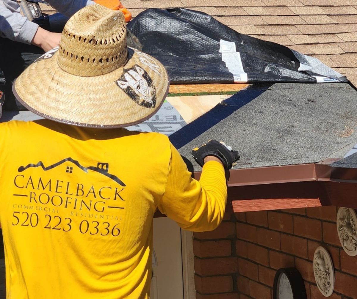 Camelback Roofing worker on a Tucson roof in branded long-sleeve