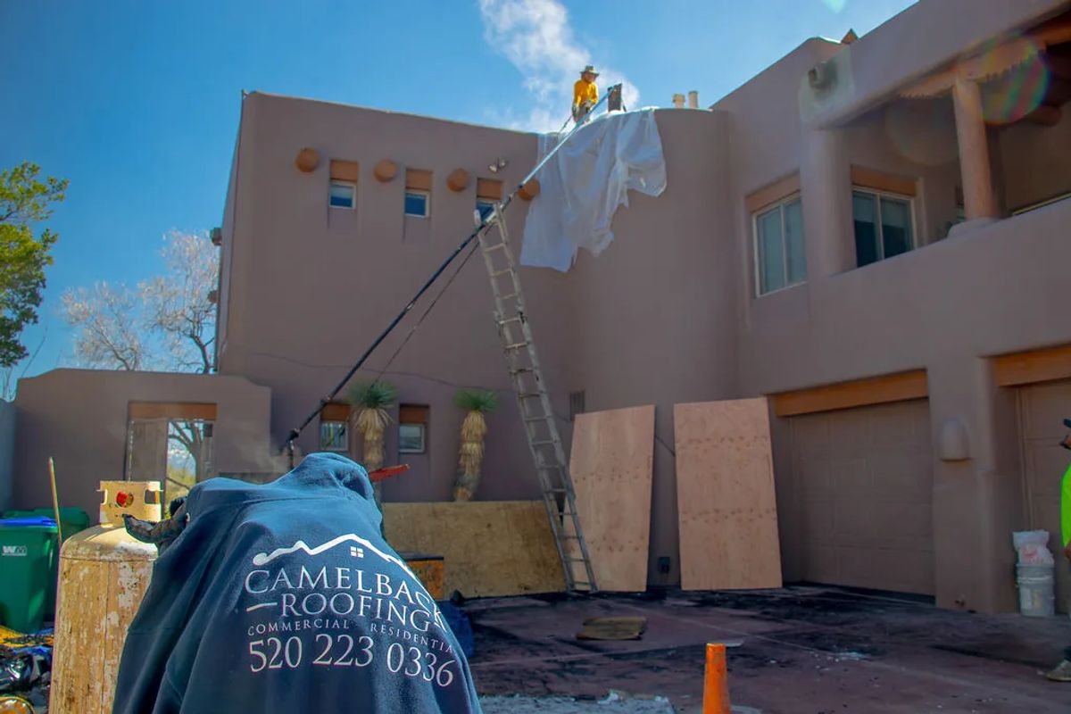 Roofer working on a southwestern adobe-style home