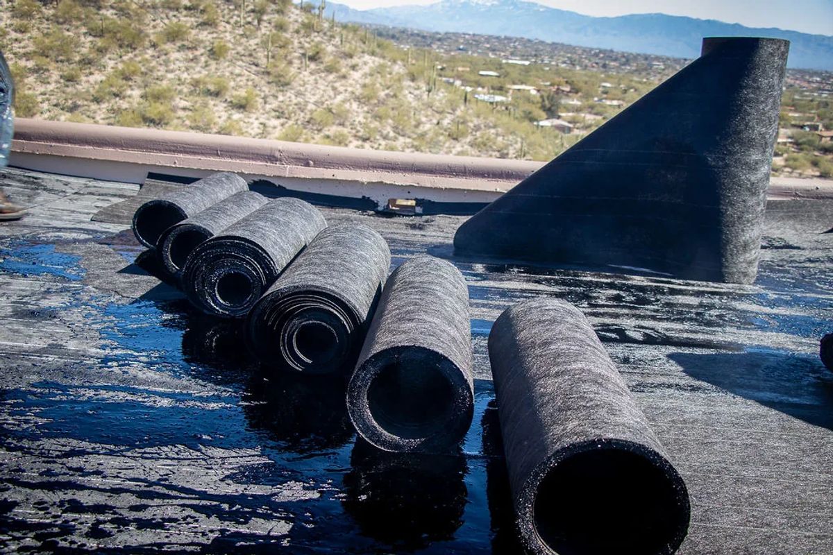 Rolls of modified bitumen membrane staged on a roof