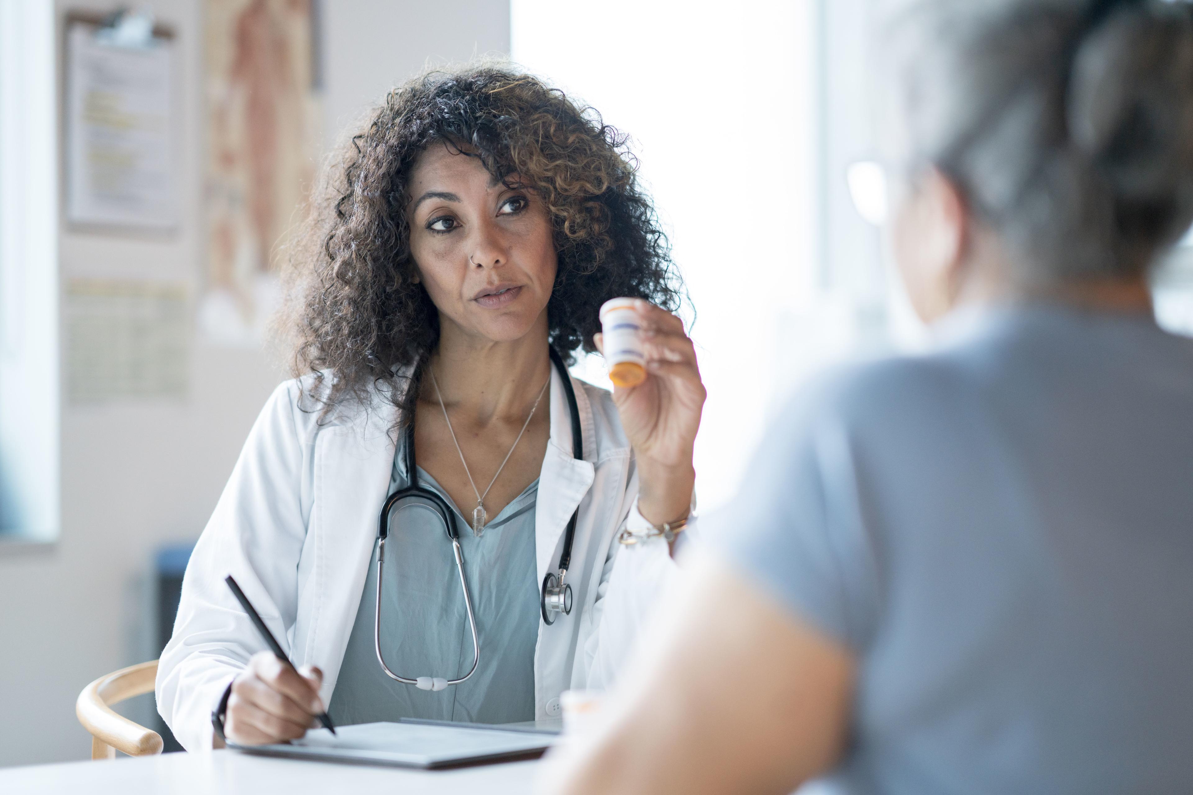 Can an fnp prescribe medication? a picture of an FNP listening to a patient.