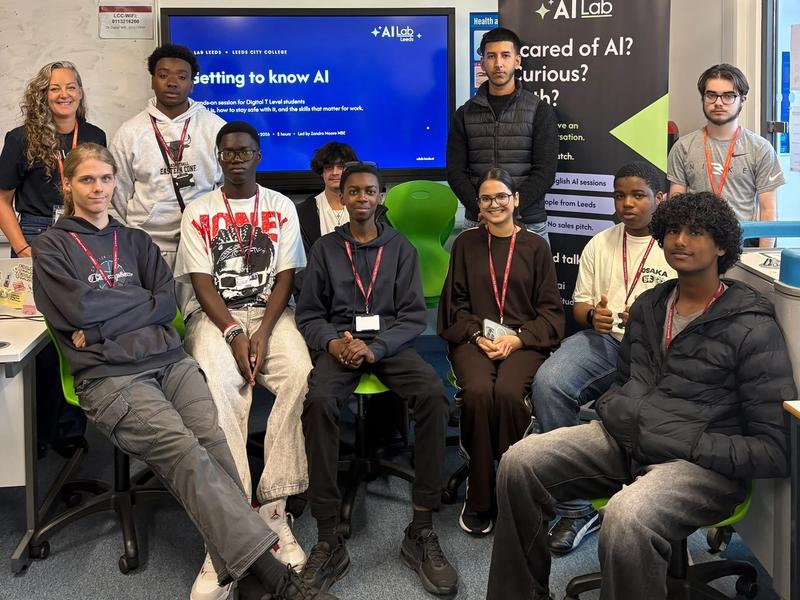 Wider view of the same group in the Leeds City College classroom, showing the full teaching space, the session slide on screen, and the AI Lab Leeds banner