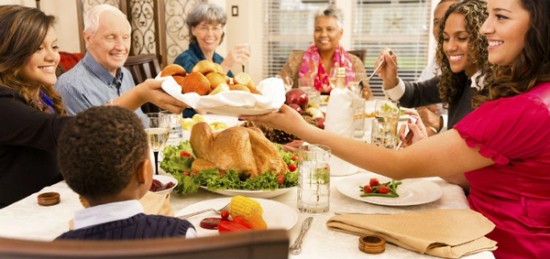 A family sharing food at a thanksgiving dinner.