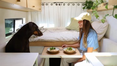 girl sharing dinner with her dog