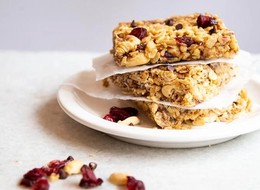 three granola bars made of peanuts and dry fruits.