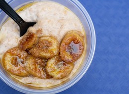 A creamy Jamaican porridge topped with golden caramelized banana slices