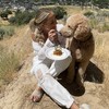 a girl eating waffles with her dog