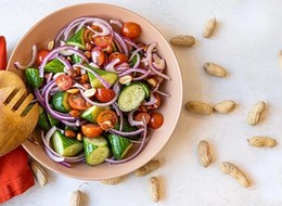 bowl of cucumber, tomato and peanut salad.