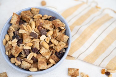 one bowl full of chocolate chips mixed with crackers, peanuts and raisins.