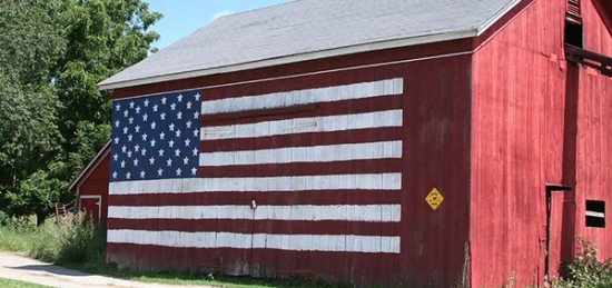 a red barn with an american flag painted on it.