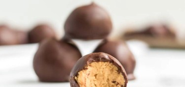 a small peanut butter ball coated in chocolate cut in half.