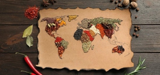 A map of the world made with spices and herbs on a piece of paper.