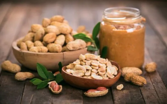 a table full of peanuts products from unshelled ones to peanut butter