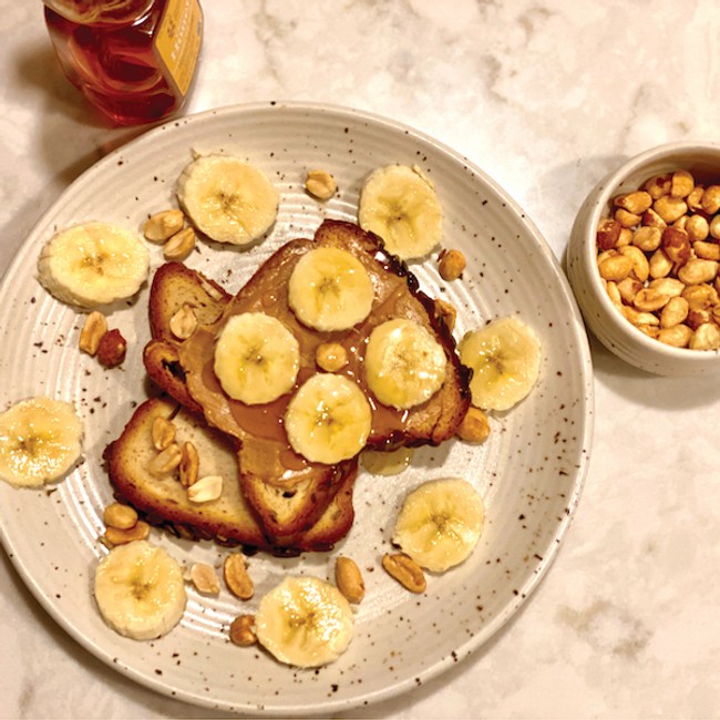 toast slices coated in peanut butter and topped with banana
