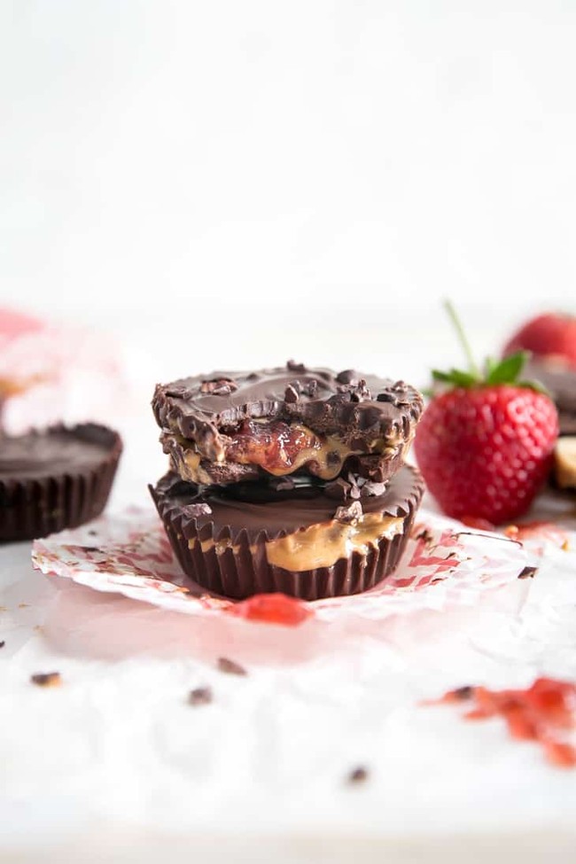 Chocolate cups filled with strawberries and peanut butter.