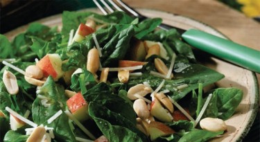 salad with green leaves, apples and peanuts.